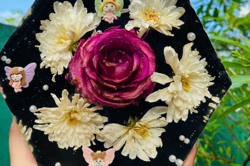 Dried roses and blooms preserved in a glossy hand-poured resin piece